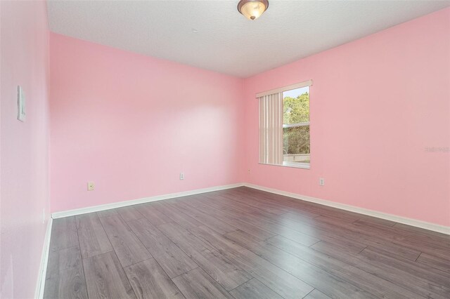 239 Beacon Pointe Dr, Ocoee, FL 34761 - spare room featuring wood finished floors, baseboards, and a textured ceiling