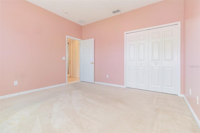 239 Beacon Pointe Dr, Ocoee, FL 34761 - unfurnished bedroom with light carpet, a closet, and baseboards