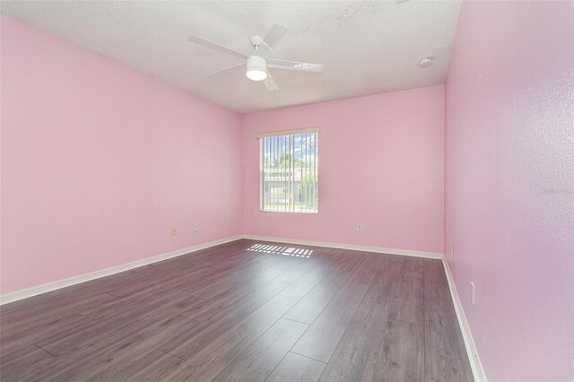 239 Beacon Pointe Dr, Ocoee, FL 34761 - spare room featuring dark wood-style flooring, ceiling fan, baseboards, and a textured ceiling