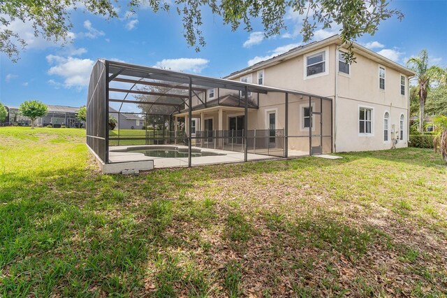 239 Beacon Pointe Dr, Ocoee, FL 34761 - rear view of property featuring a patio, stucco siding, a yard, and glass enclosure