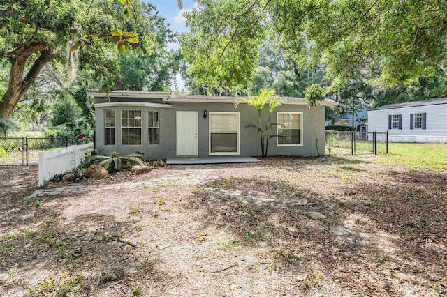 7347 Pulsar St, New Port Richey, FL 34652 - view of front facade featuring stucco siding and a gate