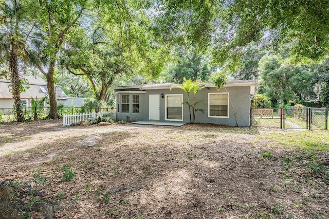 7347 Pulsar St, New Port Richey, FL 34652 - back of property featuring stucco siding, a fenced backyard, and a patio area
