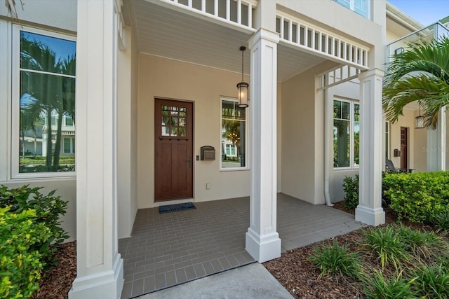 12 Country Club Ln, Belleair, FL 33756 - doorway to property featuring a porch and stucco siding