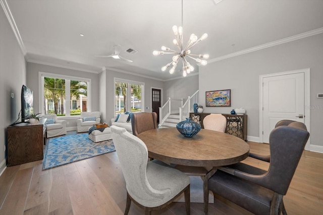 12 Country Club Ln, Belleair, FL 33756 - dining area with stairs, ornamental molding, baseboards, light wood finished floors, and a chandelier