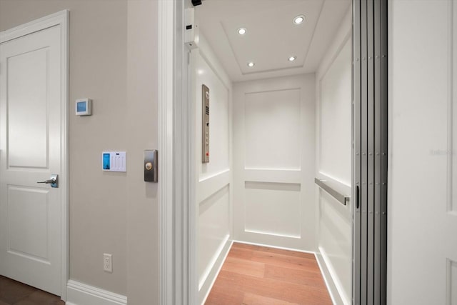 12 Country Club Ln, Belleair, FL 33756 - hall featuring elevator, light wood-style floors, recessed lighting, and baseboards