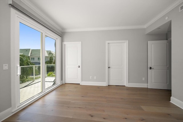 12 Country Club Ln, Belleair, FL 33756 - unfurnished bedroom featuring crown molding, access to outside, baseboards, and wood finished floors