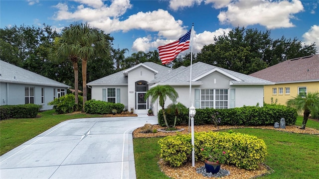 2121 Worthington Greens Dr, Sun City Center, FL 33573 - single story home with a front yard, stucco siding, and a shingled roof