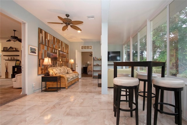 2121 Worthington Greens Dr, Sun City Center, FL 33573 - living room featuring a ceiling fan and light marble finish flooring