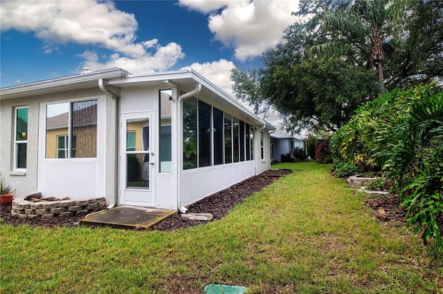 2121 Worthington Greens Dr, Sun City Center, FL 33573 - view of home's exterior featuring a sunroom and a yard