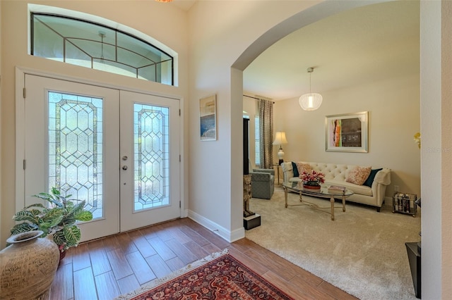 347 Cockle Shell Loop, Apollo Beach, FL 33572 - foyer with arched walkways, wood finished floors, and baseboards