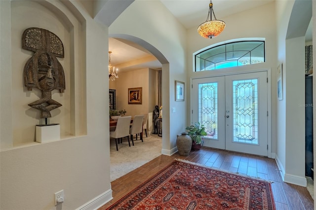 347 Cockle Shell Loop, Apollo Beach, FL 33572 - foyer featuring plenty of natural light, wood finished floors, a chandelier, and french doors