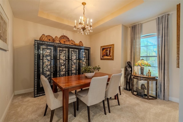 347 Cockle Shell Loop, Apollo Beach, FL 33572 - dining area with a chandelier, light colored carpet, baseboards, and a tray ceiling