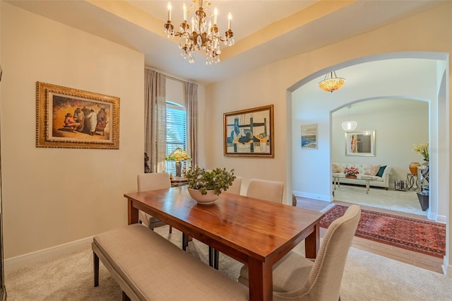 347 Cockle Shell Loop, Apollo Beach, FL 33572 - dining area with arched walkways, a chandelier, baseboards, and carpet