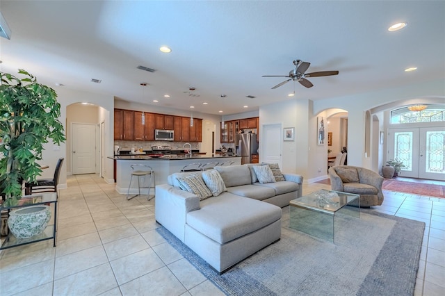 347 Cockle Shell Loop, Apollo Beach, FL 33572 - living area featuring arched walkways, light tile patterned flooring, recessed lighting, a ceiling fan, and baseboards