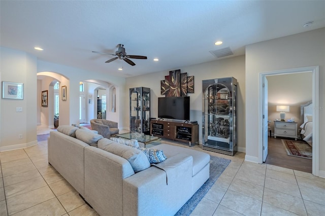 347 Cockle Shell Loop, Apollo Beach, FL 33572 - living room with arched walkways, light tile patterned floors, a ceiling fan, recessed lighting, and baseboards