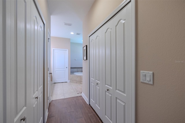 347 Cockle Shell Loop, Apollo Beach, FL 33572 - corridor featuring dark wood-type flooring and a textured wall