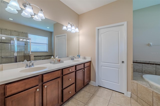 347 Cockle Shell Loop, Apollo Beach, FL 33572 - bathroom featuring double vanity, a garden tub, a stall shower, tile patterned flooring, and baseboards