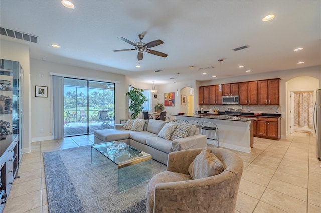 347 Cockle Shell Loop, Apollo Beach, FL 33572 - living area with arched walkways, light tile patterned floors, a ceiling fan, recessed lighting, and baseboards