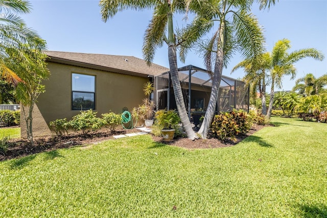 347 Cockle Shell Loop, Apollo Beach, FL 33572 - rear view of property with stucco siding, a yard, and glass enclosure