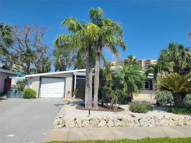 860 Bruce Ave, Clearwater Beach, FL 33767 - view of front of home featuring stucco siding, a garage, and driveway