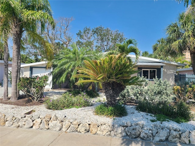 860 Bruce Ave, Clearwater Beach, FL 33767 - obstructed view of property with stucco siding and a garage