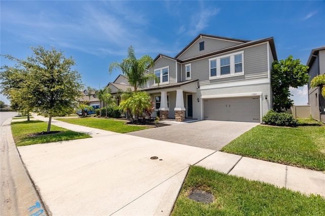 11320 Chilly Water Ct, Riverview, FL 33569 - view of front of house with decorative driveway, a garage, a front yard, and stucco siding