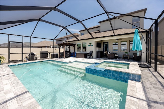 11320 Chilly Water Ct, Riverview, FL 33569 - view of swimming pool featuring a patio area, an outdoor hangout area, a ceiling fan, glass enclosure, and a pool with connected hot tub