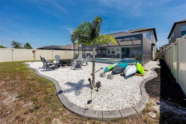 11320 Chilly Water Ct, Riverview, FL 33569 - rear view of property featuring an outdoor fire pit, a fenced backyard, a patio, and glass enclosure