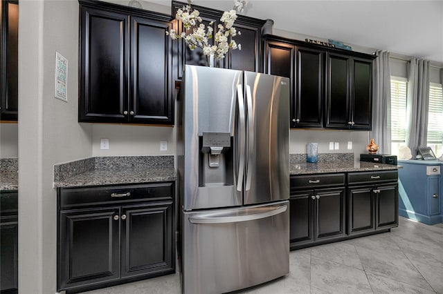 11320 Chilly Water Ct, Riverview, FL 33569 - kitchen with stainless steel fridge, dark cabinetry, and dark stone countertops
