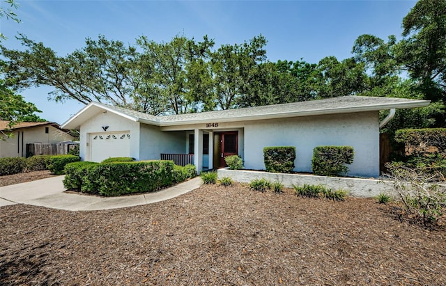 1648 Concord St, Dunedin, FL 34698 - ranch-style house with a garage, stucco siding, and covered porch
