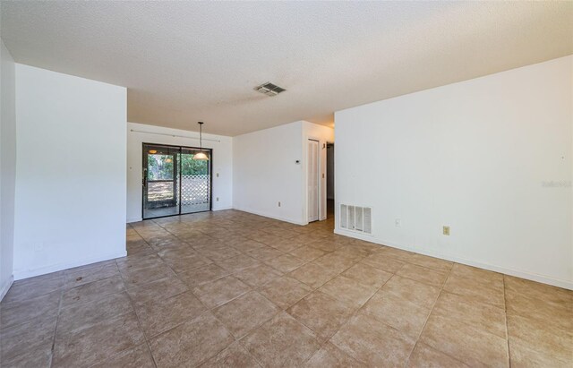 1648 Concord St, Dunedin, FL 34698 - empty room featuring baseboards and a textured ceiling