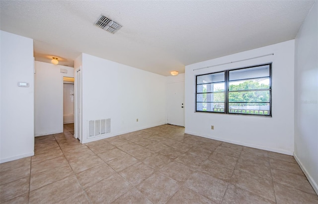1648 Concord St, Dunedin, FL 34698 - unfurnished room with a textured ceiling and light tile patterned floors
