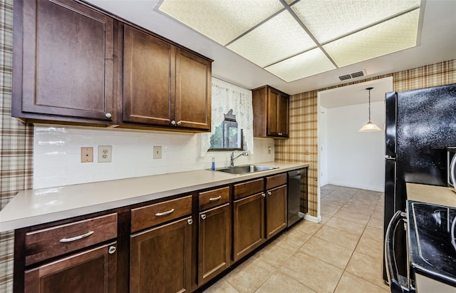 1648 Concord St, Dunedin, FL 34698 - kitchen with a sink, black appliances, wallpapered walls, light countertops, and pendant lighting