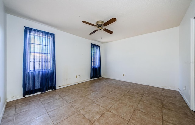 1648 Concord St, Dunedin, FL 34698 - empty room featuring plenty of natural light, a ceiling fan, and baseboards