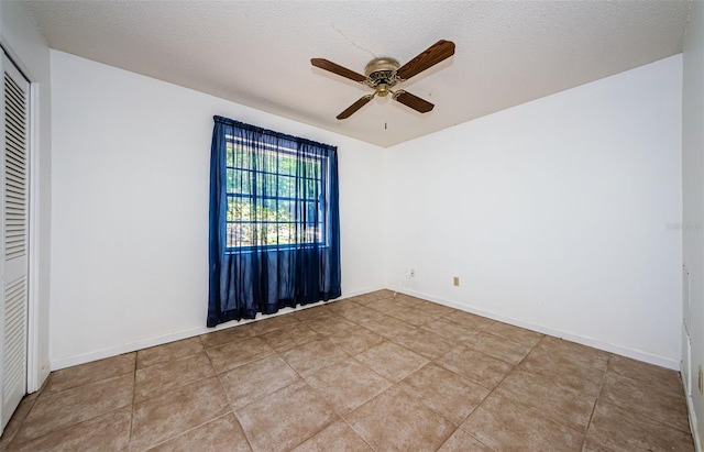 1648 Concord St, Dunedin, FL 34698 - tiled empty room featuring a ceiling fan, a textured ceiling, and baseboards