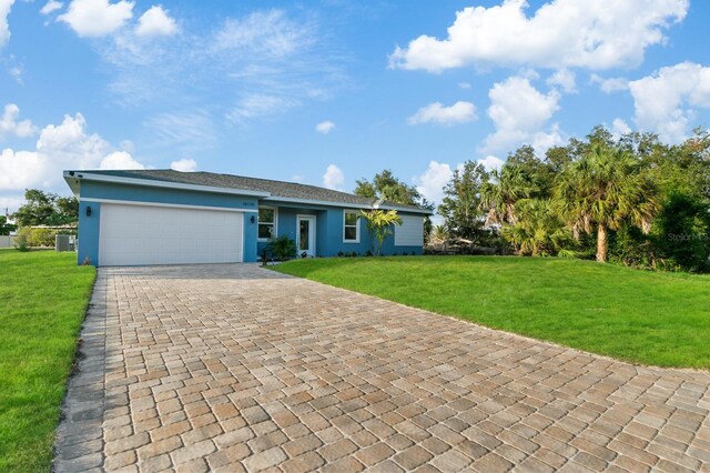 5229 Chaney Ter, Port Charlotte, FL 33981 - ranch-style home with stucco siding, decorative driveway, a front yard, and a garage