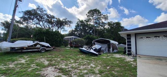 1160 W Geneva Pl, Citrus Springs, FL 34434 - view of yard with a garage