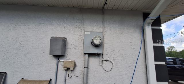 1160 W Geneva Pl, Citrus Springs, FL 34434 - exterior view of stucco siding and electric meter
