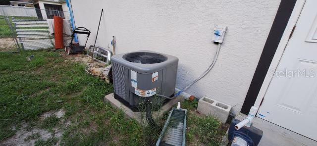 1160 W Geneva Pl, Citrus Springs, FL 34434 - exterior view of stucco siding and cooling unit