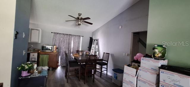 1160 W Geneva Pl, Citrus Springs, FL 34434 - dining room featuring vaulted ceiling, ceiling fan, and wood finished floors