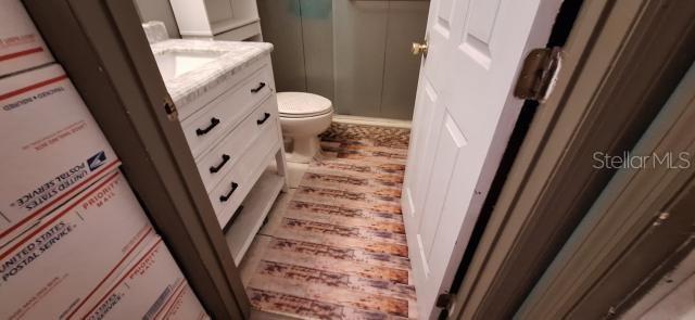 1160 W Geneva Pl, Citrus Springs, FL 34434 - bathroom with vanity, toilet, water heater, and a shower