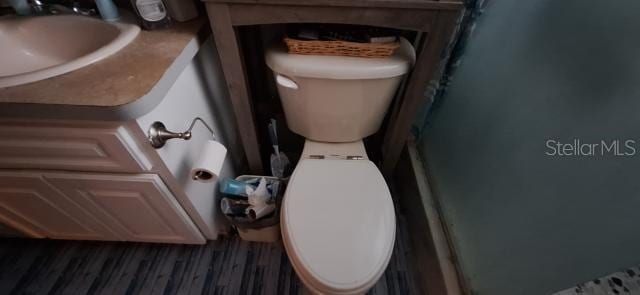 1160 W Geneva Pl, Citrus Springs, FL 34434 - full bath with toilet, wood finished floors, vanity, and a shower