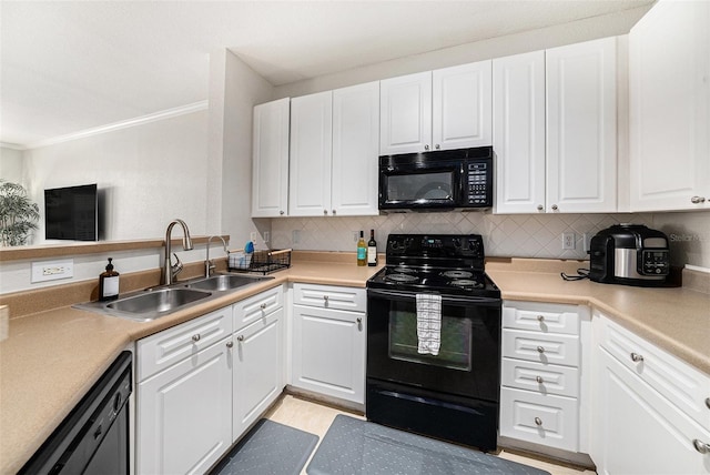 4221 W Spruce St Unit 2104, Tampa, FL 33607 - kitchen with black appliances, a sink, white cabinets, crown molding, and backsplash