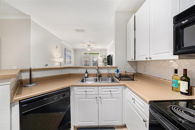 4221 W Spruce St Unit 2104, Tampa, FL 33607 - kitchen featuring black appliances, a sink, white cabinets, crown molding, and decorative backsplash