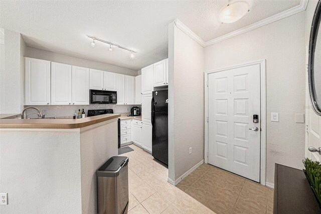 4221 W Spruce St Unit 2104, Tampa, FL 33607 - kitchen with black appliances, white cabinets, light tile patterned flooring, rail lighting, and ornamental molding