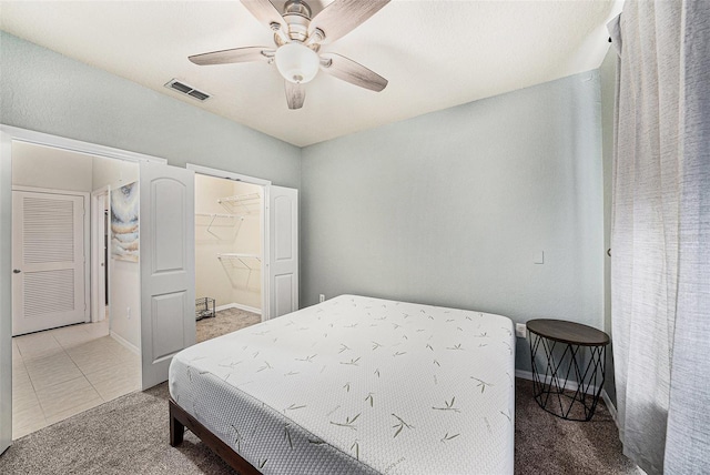 4221 W Spruce St Unit 2104, Tampa, FL 33607 - bedroom featuring carpet, a ceiling fan, a spacious closet, and baseboards