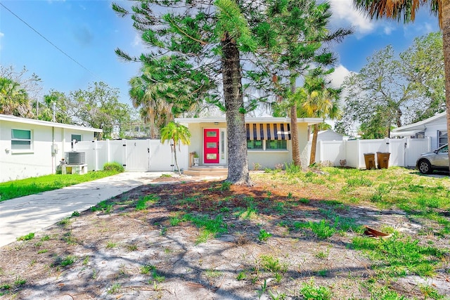 112 11th Ave, Indian Rocks Beach, FL 33785 - mid-century modern home featuring a gate, concrete driveway, central AC, and stucco siding