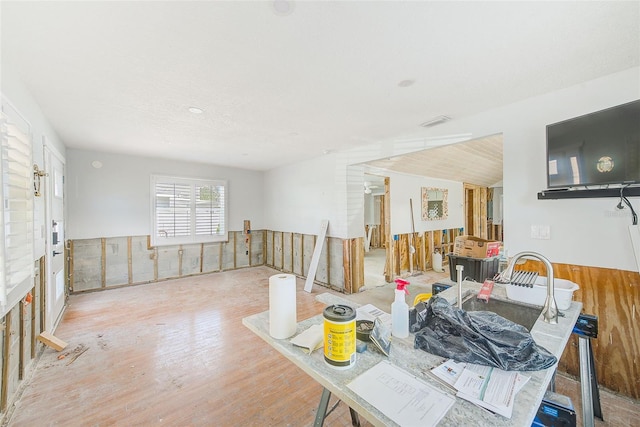 112 11th Ave, Indian Rocks Beach, FL 33785 - dining room featuring wood finished floors and a wainscoted wall