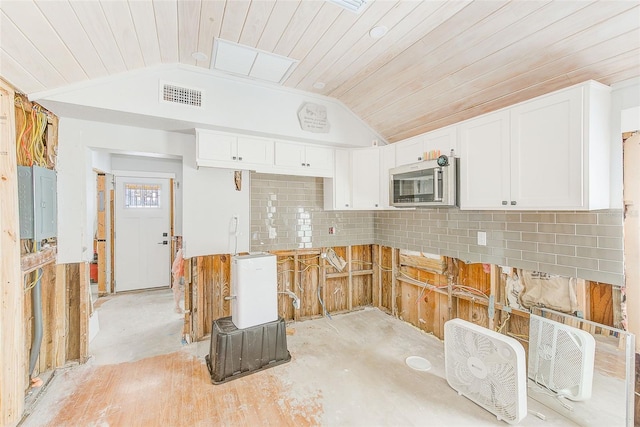 112 11th Ave, Indian Rocks Beach, FL 33785 - kitchen with lofted ceiling, white cabinetry, tasteful backsplash, and wood ceiling