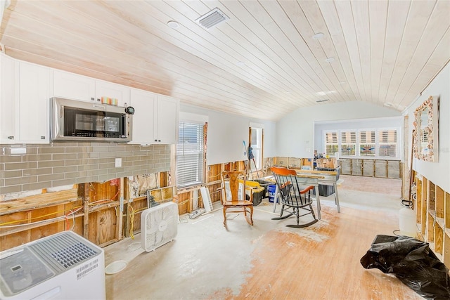 112 11th Ave, Indian Rocks Beach, FL 33785 - dining area with lofted ceiling, healthy amount of natural light, wood ceiling, and a wainscoted wall